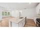 Bright kitchen with granite island offers great sightlines into adjacent living space, perfect for entertaining at 3953 Brushy St, Powder Springs, GA 30127