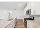 Modern kitchen with stainless steel appliances, granite countertops and bright white cabinets at 3953 Brushy St, Powder Springs, GA 30127