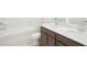 Modern bathroom with dual sinks, stylish fixtures, and a soaking tub at 3961 Brushy St, Powder Springs, GA 30127