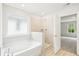 This bathroom boasts a separate tub and tiled shower with a large window view at 3961 Brushy St, Powder Springs, GA 30127