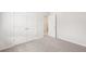 Neutral bedroom with plush carpet, a closet, and an adjacent doorway at 3961 Brushy St, Powder Springs, GA 30127