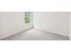Bright bedroom featuring neutral walls and plush carpet alongside a window with outside views at 3961 Brushy St, Powder Springs, GA 30127