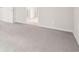The image showcases a spacious, empty room with neutral carpet and doorway at 3961 Brushy St, Powder Springs, GA 30127