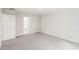 The image showcases a spacious, empty room with neutral carpet, doorway and natural light at 3961 Brushy St, Powder Springs, GA 30127