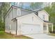 A lovely two-story home with a two-car garage and well-manicured lawn at 3961 Brushy St, Powder Springs, GA 30127