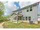 The image features a home's backyard with a covered patio at 3961 Brushy St, Powder Springs, GA 30127