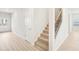 Hallway featuring carpeted stairs and hardwood floors at 3961 Brushy St, Powder Springs, GA 30127