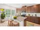 Bright kitchen features an island with granite countertops, stainless steel appliances, and wood cabinets at 3961 Brushy St, Powder Springs, GA 30127