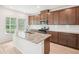 Bright kitchen features an island with granite countertops, stainless steel appliances, and wood cabinets at 3961 Brushy St, Powder Springs, GA 30127