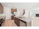 Open kitchen with a large island, stainless steel appliances, and view of the living area at 3961 Brushy St, Powder Springs, GA 30127