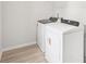 The laundry room features modern appliances and sleek countertops on top of new plank flooring at 3961 Brushy St, Powder Springs, GA 30127