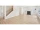 Bright living room featuring wood-look floors, a fireplace, and large windows at 3961 Brushy St, Powder Springs, GA 30127