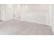 An open loft area with plush carpet and ample lighting from natural light at 3961 Brushy St, Powder Springs, GA 30127