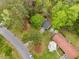 Aerial view of a home with mature trees and a long driveway in a residential neighborhood at 4595 Fradon Ct, Atlanta, GA 30349