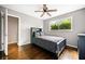Cozy bedroom with hardwood floors, ceiling fan and view of backyard at 4595 Fradon Ct, Atlanta, GA 30349