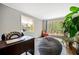 Bright bedroom with a large window offering a scenic view, complemented by modern decor and comfortable furnishings at 4595 Fradon Ct, Atlanta, GA 30349