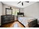 Well-lit bedroom with hardwood floors, modern furniture, and a large window offering a serene view at 4595 Fradon Ct, Atlanta, GA 30349