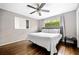 Comfortable bedroom with hardwood floors, a large window, and a modern ceiling fan at 4595 Fradon Ct, Atlanta, GA 30349