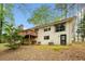 Rear exterior of a brick home with a wooden deck and walkout basement entrance at 4595 Fradon Ct, Atlanta, GA 30349