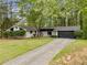 Single-story home with a long driveway and beautiful landscaping, nestled in a quiet, tree-lined neighborhood at 4595 Fradon Ct, Atlanta, GA 30349