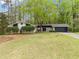 Charming single-story home featuring a manicured lawn and mature trees in a serene, residential neighborhood at 4595 Fradon Ct, Atlanta, GA 30349