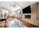 Cozy living room featuring a brick fireplace, hardwood floors, and ample natural light creating a warm atmosphere at 4595 Fradon Ct, Atlanta, GA 30349