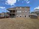 Rear exterior with deck overlooking the backyard space and brick elevation at 5458 Summer Pine Pl, Buford, GA 30518