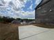 View of the backyard, showing the patio and surrounding landscape at 5458 Summer Pine Pl, Buford, GA 30518