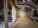 Unfinished basement with exposed utilities, wood framing, and a treadmill in view at 5458 Summer Pine Pl, Buford, GA 30518