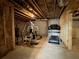 Unfinished basement with exposed wood framing and concrete floors, set up with gym equipment at 5458 Summer Pine Pl, Buford, GA 30518