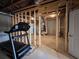 Unfinished basement with exposed wood framing and concrete floors; includes a treadmill at 5458 Summer Pine Pl, Buford, GA 30518