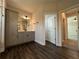 Elegant bathroom featuring wood floors, double vanity, and neutral walls at 5458 Summer Pine Pl, Buford, GA 30518