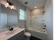 This bathroom features a shower-tub combo with a white tub surround, complemented by a gray vanity sink at 5458 Summer Pine Pl, Buford, GA 30518