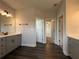 Elegant bathroom featuring wood floors, double vanity, and neutral walls at 5458 Summer Pine Pl, Buford, GA 30518
