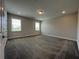 Spacious bedroom with two windows, carpet, and neutral colored walls at 5458 Summer Pine Pl, Buford, GA 30518