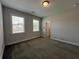 Bedroom with neutral walls, carpet, and two windows with blinds at 5458 Summer Pine Pl, Buford, GA 30518