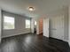 A spacious bedroom with hardwood floors, two windows, and white closet doors offers ample natural light at 5458 Summer Pine Pl, Buford, GA 30518