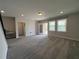 A bonus room featuring plush carpeting, recessed lights, a walk-out patio and staircase to upper level at 5458 Summer Pine Pl, Buford, GA 30518