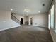 Open bonus room with plush gray carpeting, neutral paint, staircase, and bright, natural light at 5458 Summer Pine Pl, Buford, GA 30518