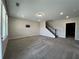 Spacious bonus room featuring plush gray carpet, recessed lighting, and staircase leading to upper level at 5458 Summer Pine Pl, Buford, GA 30518
