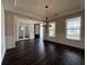 Formal dining area featuring dark wood floors, modern chandelier, and bright windows at 5458 Summer Pine Pl, Buford, GA 30518