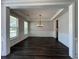 Formal dining room featuring elegant trim work, neutral tones, and a modern chandelier at 5458 Summer Pine Pl, Buford, GA 30518
