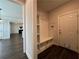 Functional entryway with built-in storage bench and coat hooks, leading to the living area at 5458 Summer Pine Pl, Buford, GA 30518