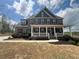 Stately two-story brick home with a welcoming front porch and fresh landscaping at 5458 Summer Pine Pl, Buford, GA 30518