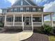 Beautiful front porch with classic white columns, brick accents and a welcoming entrance at 5458 Summer Pine Pl, Buford, GA 30518