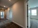 Hallway with neutral walls and carpet, leading to various rooms at 5458 Summer Pine Pl, Buford, GA 30518