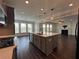 Gourmet kitchen featuring a center island, stainless steel appliances, and an open layout at 5458 Summer Pine Pl, Buford, GA 30518