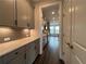 Modern kitchen featuring sleek gray cabinets, quartz countertops, and stainless steel appliances at 5458 Summer Pine Pl, Buford, GA 30518