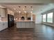 Modern kitchen featuring pendant lights, stainless steel appliances, and an open-concept design at 5458 Summer Pine Pl, Buford, GA 30518