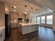 Modern kitchen featuring a large island, stainless steel appliances, and ample cabinet space at 5458 Summer Pine Pl, Buford, GA 30518